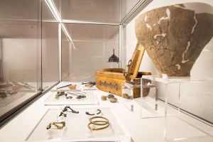 Gablota wystawowa z eksponatami, m. in. z misą, metalowymi i drewnianymi narzędziami.