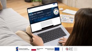 Kobieta na sofie trzyma laptopa na kolanach.