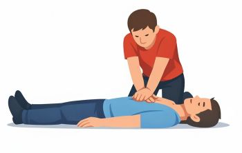 Mężczyzna pochyla się nad nieprzytomnym człowiekiem i uciska jego klatkę piersiową.