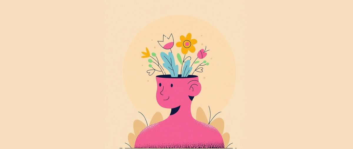 Rysunkowe przedstawienie przekroju głowy uśmiechniętego człowieka, z którego wystają kwiaty.