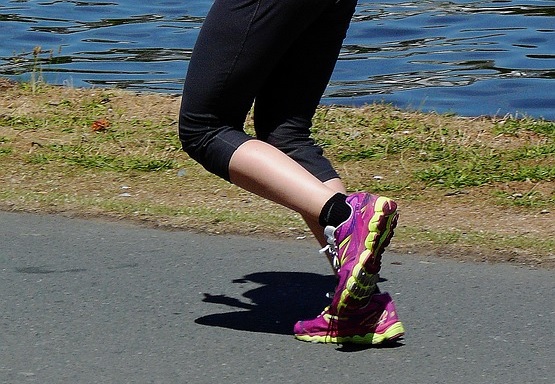 Nogi biegaczki w obuwiu sportowym.