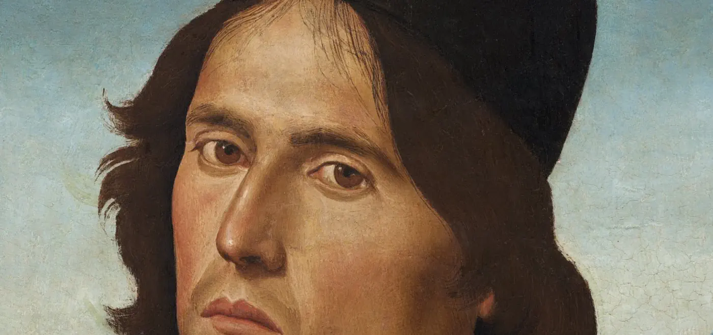 Zbliżenie na twarz mężczyzny z renesansowego obrazu.